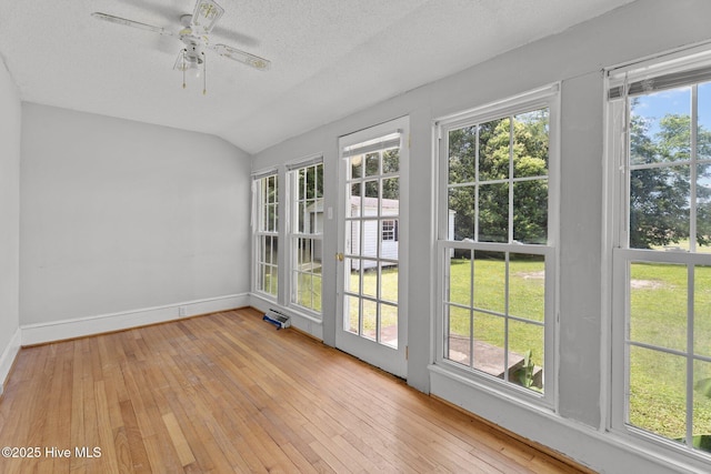 6074 NC-42 Hwy W, Macclesfield, NC 27852 - unfurnished sunroom featuring lofted ceiling, a textured ceiling, and wood-type flooring