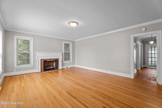 6074 NC-42 Hwy W, Macclesfield, NC 27852 - unfurnished living room featuring crown molding, light wood-type flooring, a fireplace, and attic access