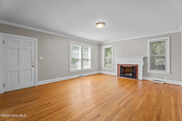 6074 NC-42 Hwy W, Macclesfield, NC 27852 - unfurnished living room featuring light wood-style flooring, ornamental molding, and a fireplace