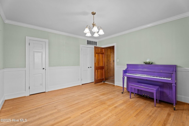 6074 NC-42 Hwy W, Macclesfield, NC 27852 - living area with a chandelier, wood finished floors, wainscoting, and ornamental molding