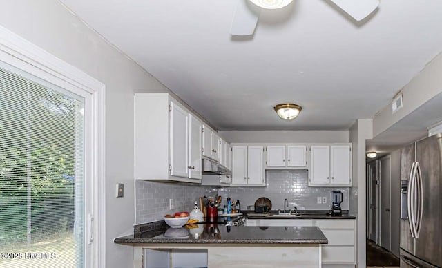 105 Woodside Ct, Jacksonville, NC 28546 - kitchen with stainless steel fridge, under cabinet range hood, tasteful backsplash, and a peninsula