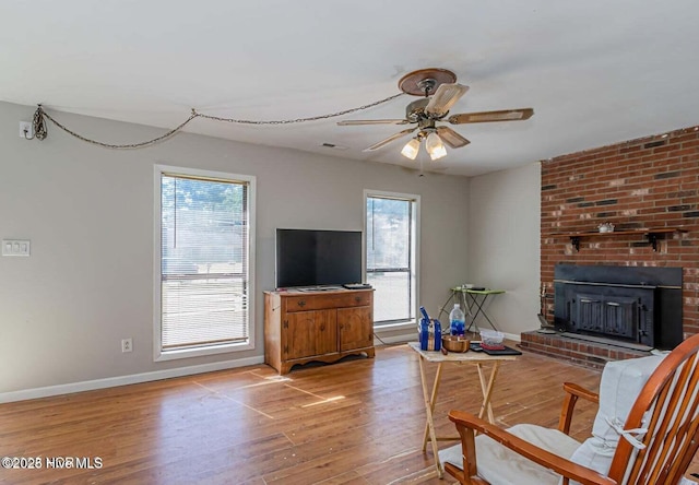 105 Woodside Ct, Jacksonville, NC 28546 - living room with wood finished floors, ceiling fan, and a fireplace