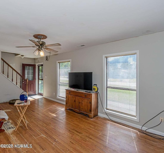 105 Woodside Ct, Jacksonville, NC 28546 - living area with stairs, light wood-type flooring, and a ceiling fan