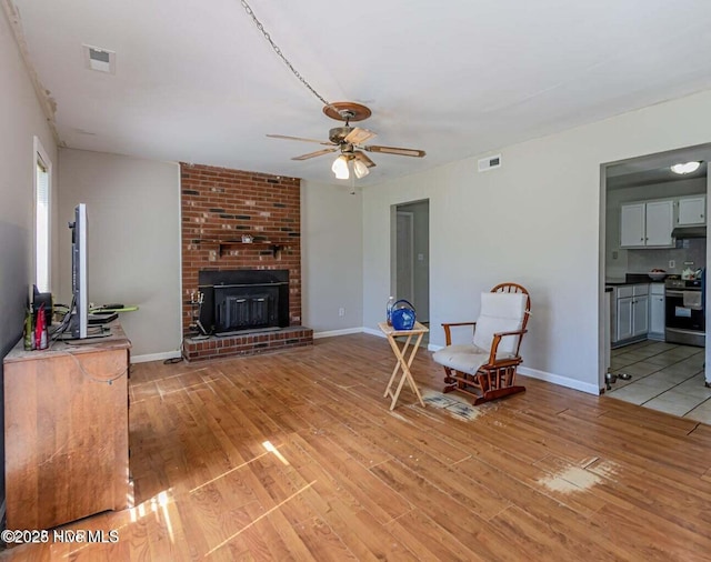 105 Woodside Ct, Jacksonville, NC 28546 - living area featuring ceiling fan, light wood-style flooring, and a fireplace