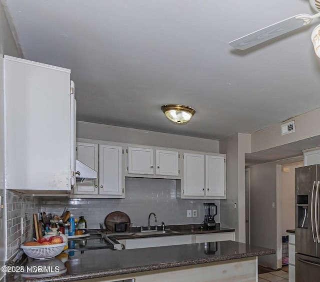 105 Woodside Ct, Jacksonville, NC 28546 - kitchen featuring stainless steel fridge with ice dispenser, backsplash, exhaust hood, and white cabinets