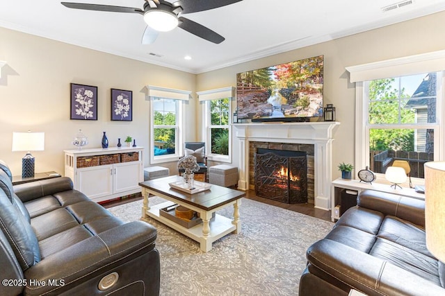 26 Calhoun Ln, Pinehurst, NC 28374 - living room featuring wood finished floors, a ceiling fan, a warm lit fireplace, ornamental molding, and recessed lighting