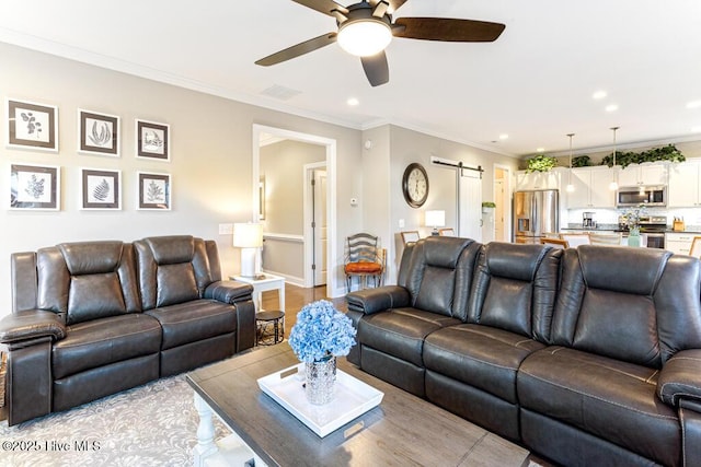 26 Calhoun Ln, Pinehurst, NC 28374 - living area featuring a ceiling fan, recessed lighting, a barn door, ornamental molding, and wood finished floors
