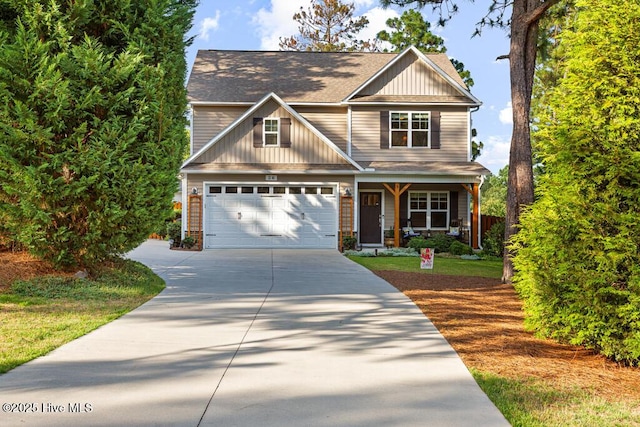 26 Calhoun Ln, Pinehurst, NC 28374 - craftsman-style home with driveway, a porch, an attached garage, roof with shingles, and board and batten siding