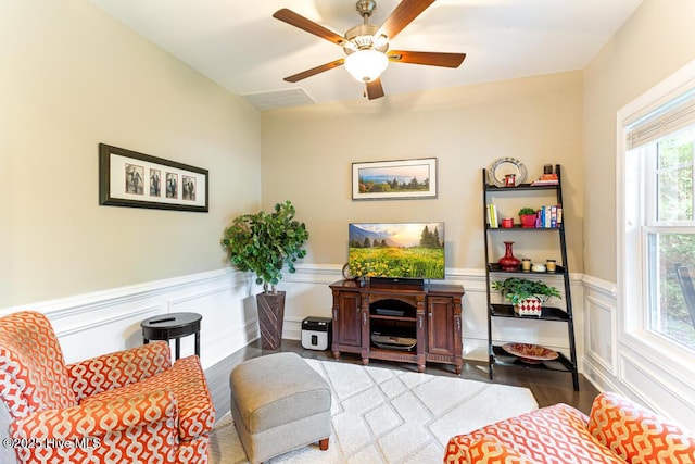 26 Calhoun Ln, Pinehurst, NC 28374 - living area featuring wood finished floors, a wainscoted wall, and a ceiling fan