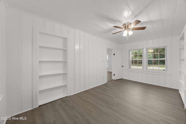 350 Hubert Blvd, Hubert, NC 28539 - unfurnished living room featuring built in shelves, a ceiling fan, wood finished floors, and a decorative wall