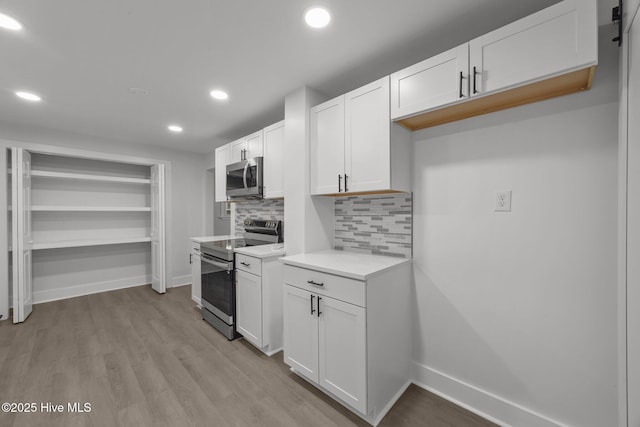 350 Hubert Blvd, Hubert, NC 28539 - kitchen with appliances with stainless steel finishes, recessed lighting, white cabinetry, backsplash, and light countertops
