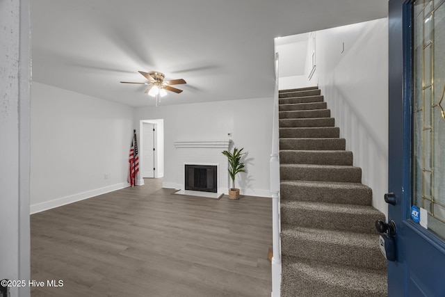 350 Hubert Blvd, Hubert, NC 28539 - unfurnished living room featuring stairway, ceiling fan, a brick fireplace, and wood finished floors