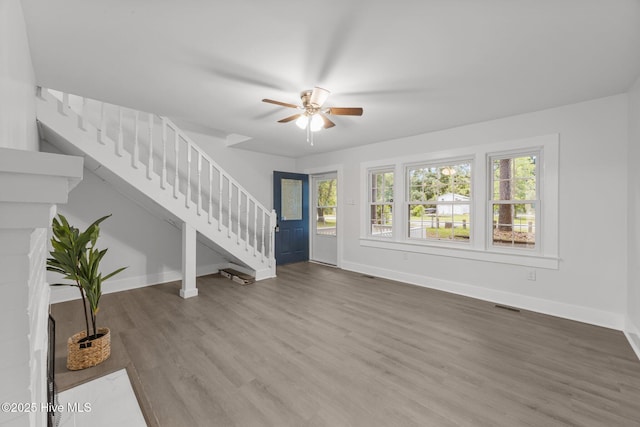 350 Hubert Blvd, Hubert, NC 28539 - unfurnished living room with stairs, ceiling fan, and wood finished floors