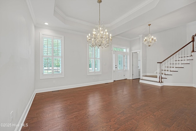 311 S Kingfisher Ln, Hampstead, NC 28443 - foyer entrance with a chandelier, dark wood-style floors, stairs, a raised ceiling, and crown molding
