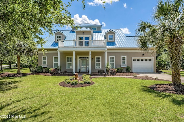 311 S Kingfisher Ln, Hampstead, NC 28443 - view of front facade featuring a balcony, stucco siding, and a standing seam roof