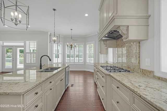 311 S Kingfisher Ln, Hampstead, NC 28443 - kitchen featuring appliances with stainless steel finishes, a chandelier, dark wood-style floors, decorative backsplash, and crown molding