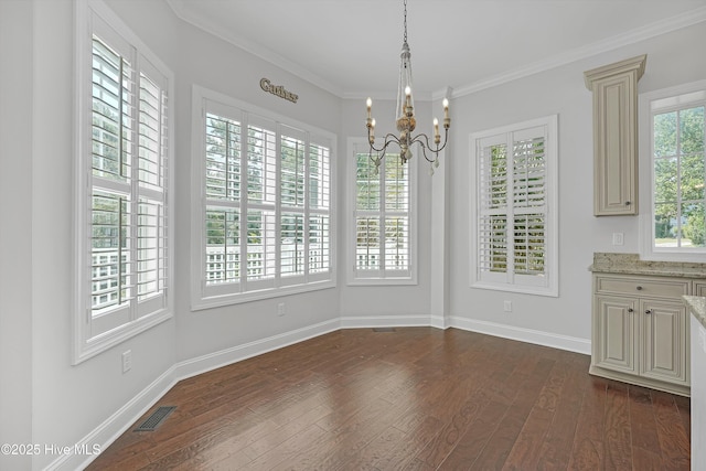 311 S Kingfisher Ln, Hampstead, NC 28443 - unfurnished dining area with dark wood-style floors, a chandelier, and crown molding