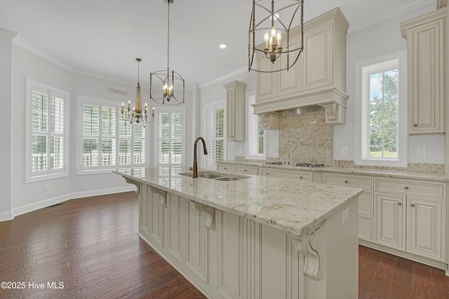 311 S Kingfisher Ln, Hampstead, NC 28443 - kitchen with a chandelier, cream cabinetry, light stone countertops, decorative backsplash, and ornamental molding