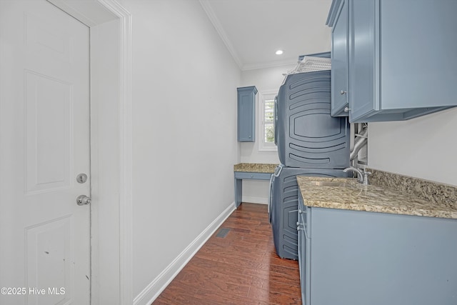 311 S Kingfisher Ln, Hampstead, NC 28443 - laundry room with cabinet space, ornamental molding, estacked washer and dryer, dark wood-style flooring, and recessed lighting