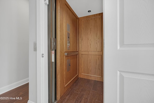 311 S Kingfisher Ln, Hampstead, NC 28443 - corridor featuring dark wood-style floors and elevator