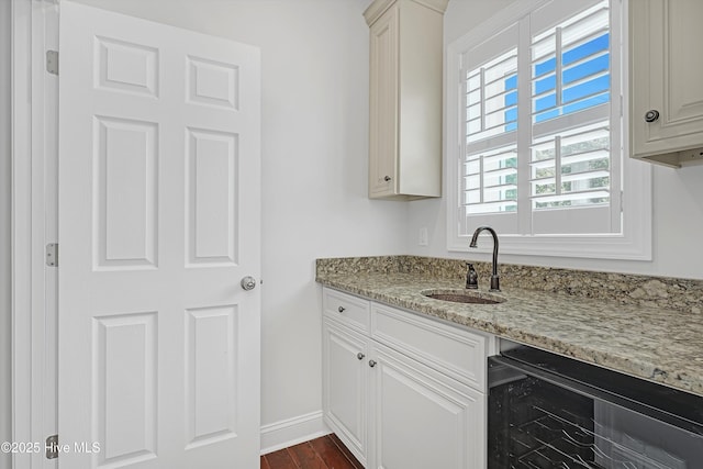 311 S Kingfisher Ln, Hampstead, NC 28443 - kitchen featuring wine cooler, light stone counters, and dark wood-style flooring