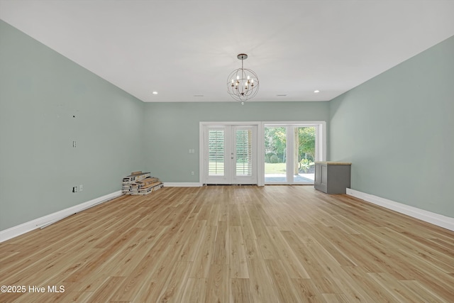 311 S Kingfisher Ln, Hampstead, NC 28443 - unfurnished living room featuring light wood finished floors, a chandelier, and recessed lighting