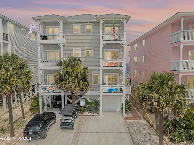 1602 Carolina Beach Ave N Unit 2, Carolina Beach, NC 28428 - view of front facade with a garage, concrete driveway, a balcony, and a carport