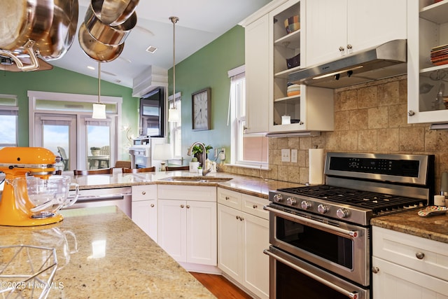1602 Carolina Beach Ave N Unit 2, Carolina Beach, NC 28428 - kitchen with appliances with stainless steel finishes, under cabinet range hood, plenty of natural light, decorative backsplash, and vaulted ceiling