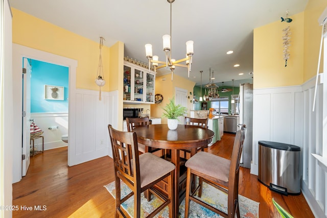 1602 Carolina Beach Ave N Unit 2, Carolina Beach, NC 28428 - dining room featuring a chandelier, a decorative wall, a wainscoted wall, wood finished floors, and recessed lighting