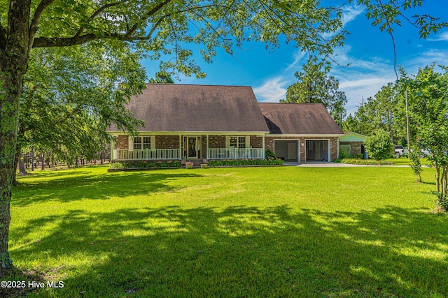 409 S Grace Chapel Church Rd, Hamlet, NC 28345 - view of front of property with brick siding, concrete driveway, covered porch, and an attached carport
