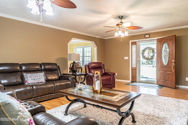 409 S Grace Chapel Church Rd, Hamlet, NC 28345 - living room with ceiling fan, arched walkways, light wood-style floors, and crown molding