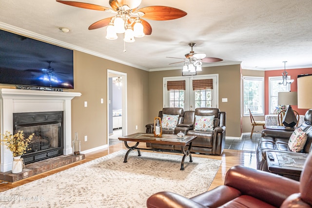 409 S Grace Chapel Church Rd, Hamlet, NC 28345 - living room with healthy amount of natural light, a ceiling fan, a glass covered fireplace, and ornamental molding