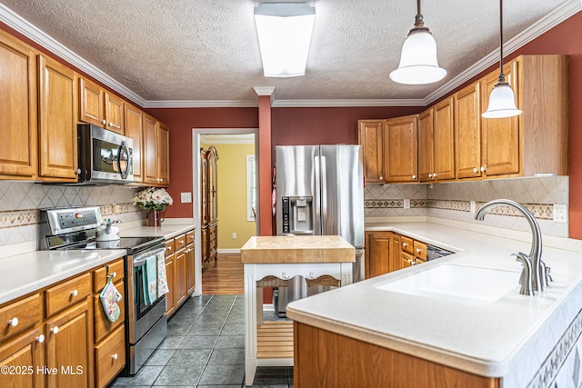 409 S Grace Chapel Church Rd, Hamlet, NC 28345 - kitchen featuring stainless steel appliances, light countertops, brown cabinetry, backsplash, and a textured ceiling