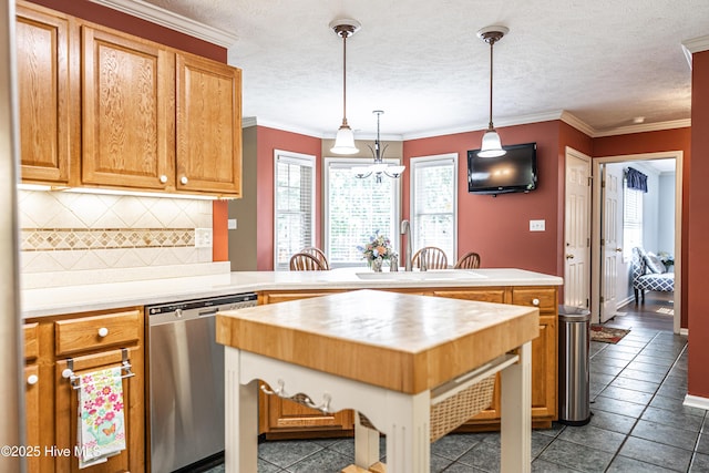 409 S Grace Chapel Church Rd, Hamlet, NC 28345 - kitchen with stainless steel dishwasher, a peninsula, backsplash, a chandelier, and hanging light fixtures