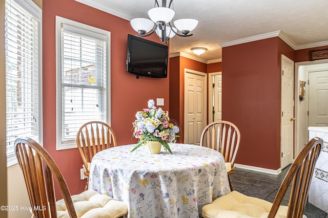 409 S Grace Chapel Church Rd, Hamlet, NC 28345 - dining room with a chandelier, dark tile patterned floors, and crown molding