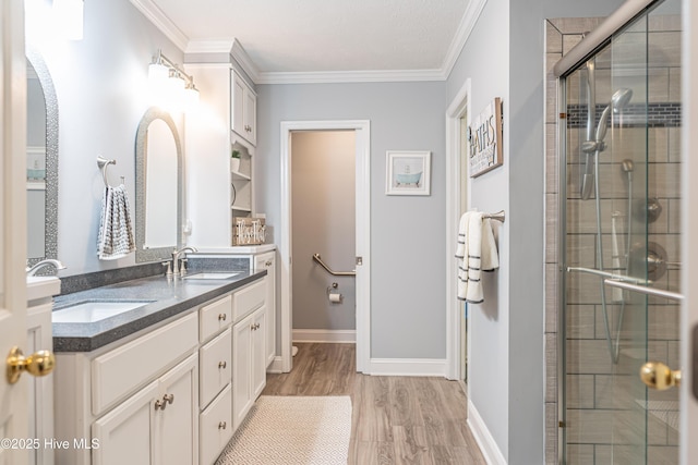 409 S Grace Chapel Church Rd, Hamlet, NC 28345 - bathroom with double vanity, a shower stall, wood finished floors, and crown molding