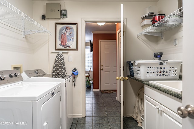 409 S Grace Chapel Church Rd, Hamlet, NC 28345 - washroom featuring separate washer and dryer, dark tile patterned floors, and cabinet space