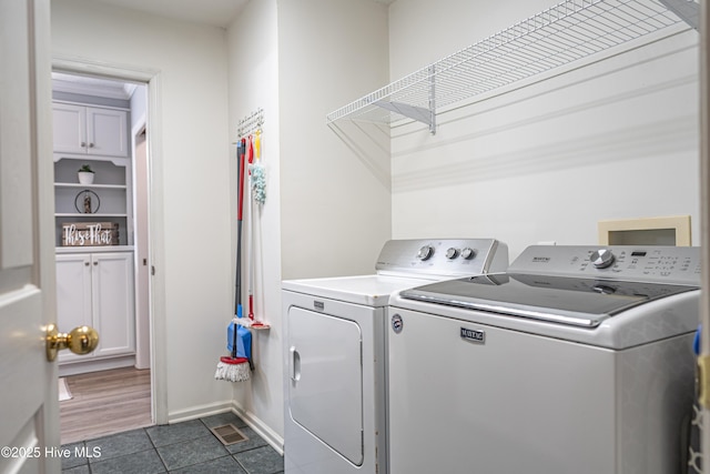 409 S Grace Chapel Church Rd, Hamlet, NC 28345 - washroom featuring washer and clothes dryer and dark tile patterned floors