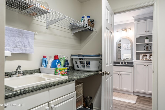 409 S Grace Chapel Church Rd, Hamlet, NC 28345 - laundry area with wood finished floors and arched walkways