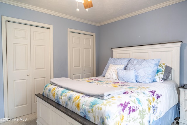 409 S Grace Chapel Church Rd, Hamlet, NC 28345 - bedroom featuring two closets, ornamental molding, and ceiling fan