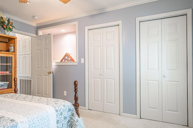 409 S Grace Chapel Church Rd, Hamlet, NC 28345 - bedroom featuring crown molding, multiple closets, speckled floor, and a ceiling fan