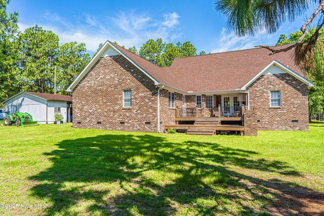 409 S Grace Chapel Church Rd, Hamlet, NC 28345 - rear view of house featuring crawl space, brick siding, a wooden deck, and a yard