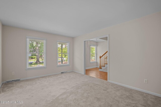3313 Aster Ct, Wilmington, NC 28409 - carpeted spare room with baseboards and stairway
