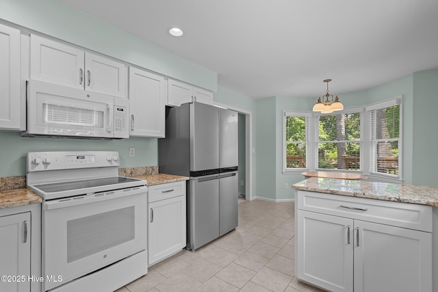 3313 Aster Ct, Wilmington, NC 28409 - kitchen featuring white appliances, white cabinetry, light tile patterned floors, hanging light fixtures, and recessed lighting