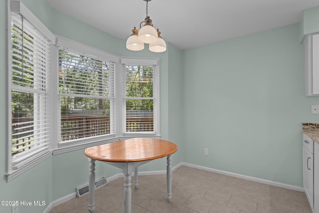 3313 Aster Ct, Wilmington, NC 28409 - dining space featuring baseboards and a chandelier