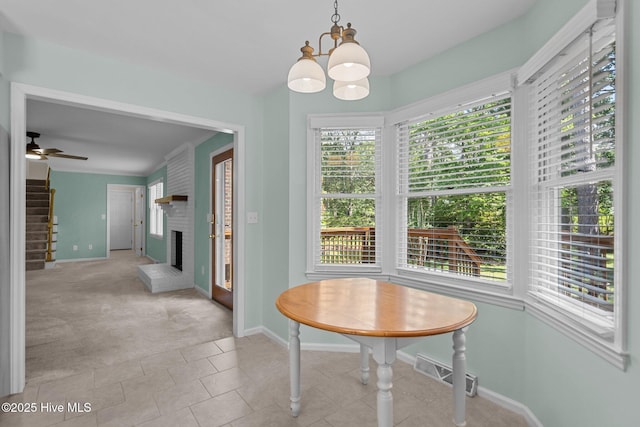3313 Aster Ct, Wilmington, NC 28409 - carpeted dining room with healthy amount of natural light, a chandelier, and a fireplace
