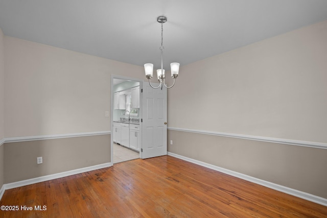 3313 Aster Ct, Wilmington, NC 28409 - empty room with a chandelier and light wood-style floors