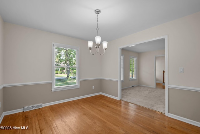 3313 Aster Ct, Wilmington, NC 28409 - empty room featuring a chandelier and wood finished floors