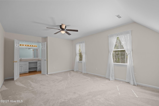 3313 Aster Ct, Wilmington, NC 28409 - unfurnished bedroom featuring carpet floors, a ceiling fan, connected bathroom, and lofted ceiling