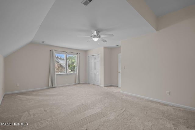 3313 Aster Ct, Wilmington, NC 28409 - unfurnished bedroom featuring light carpet, a closet, vaulted ceiling, and ceiling fan